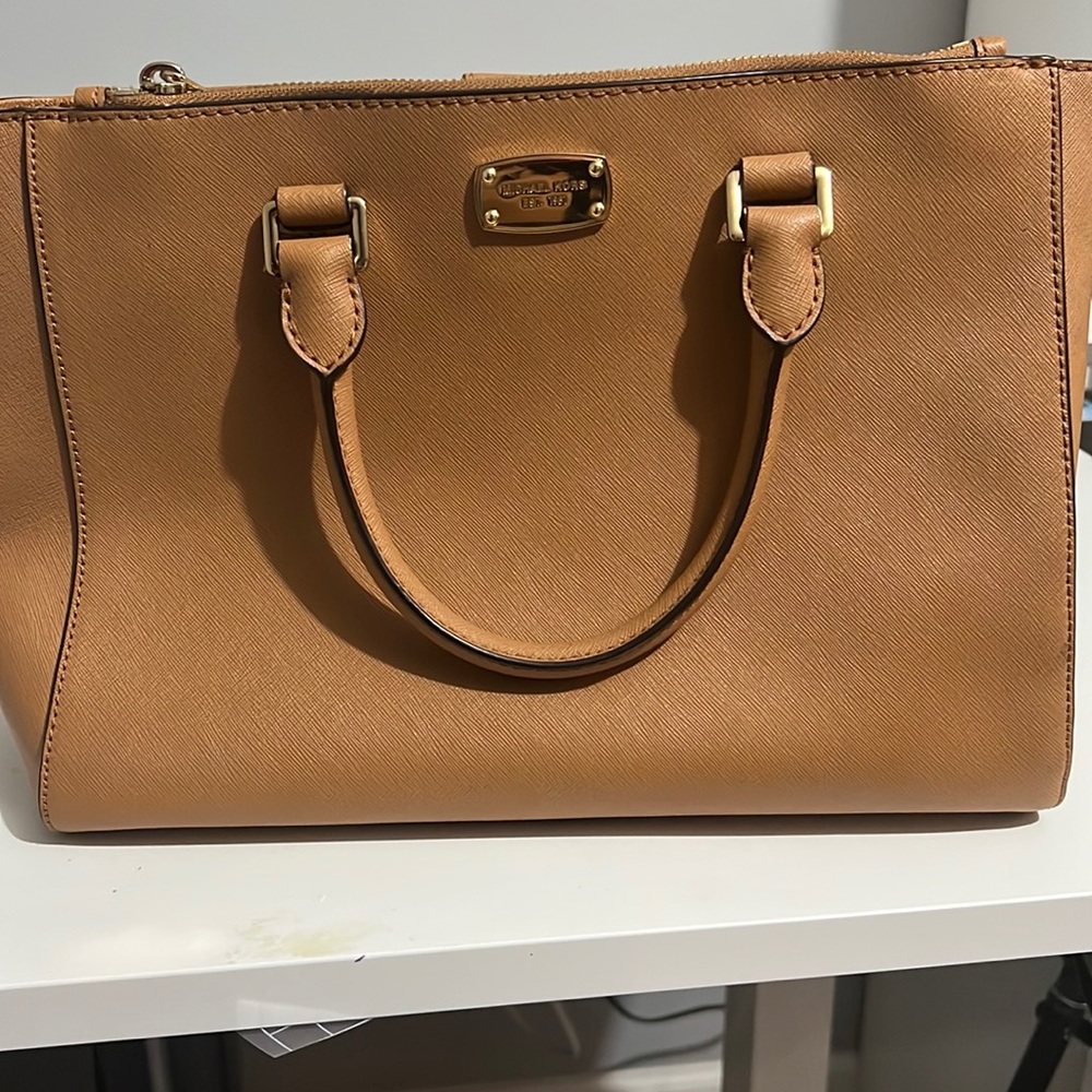 Michael Kors handbag. Tan color with gold zipper and buttons. Great condition